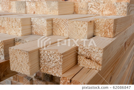 Close-up of unevenly protruding sawn rectangular wooden pine blocks . At the ends of visible tree fiber. Close-up of unevenly protruding sawn rectangular wooden pine blocks . At the ends of visible tree fiber. 62086847