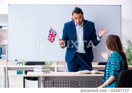 Male english teacher and female student in the classroom Male english teacher and female student in the classroom 62087157
