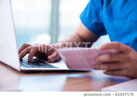 Young male doctor cardiologist working in the clinic 62087576