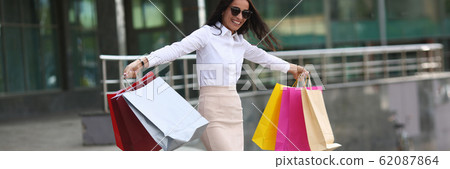 Smiling lady happy with purchases 62087864