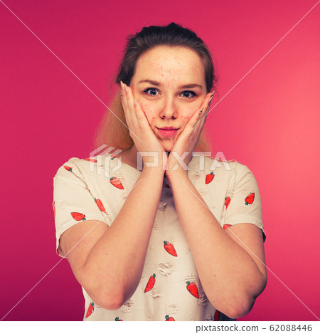 Portrait of teen girl touching her face and 62088446