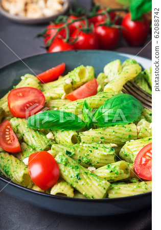 Homemade tortiglioni pasta with vegan pesto sauce Homemade tortiglioni pasta with vegan pesto sauce 62088742