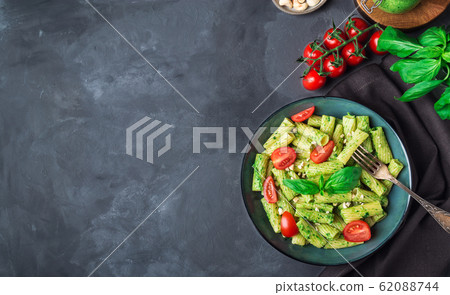 Homemade tortiglioni pasta with vegan pesto sauce Homemade tortiglioni pasta with vegan pesto sauce 62088744