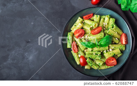 Homemade tortiglioni pasta with vegan pesto sauce Homemade tortiglioni pasta with vegan pesto sauce 62088747