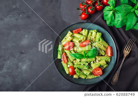 Homemade tortiglioni pasta with vegan pesto sauce Homemade tortiglioni pasta with vegan pesto sauce 62088749