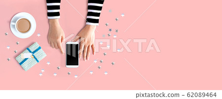 Smartphone with coffee and gift box Smartphone with coffee and gift box 62089464