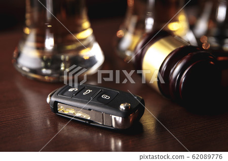 Drinking and driving concept. Car key on a wooden table, pub 62089776