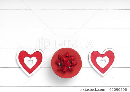 Hearts, gift on white wooden surface. Valentine's 62090306