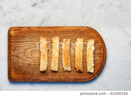 Pancakes with cottage cheese on old cutting wooden Pancakes with cottage cheese on old cutting wooden 62090388