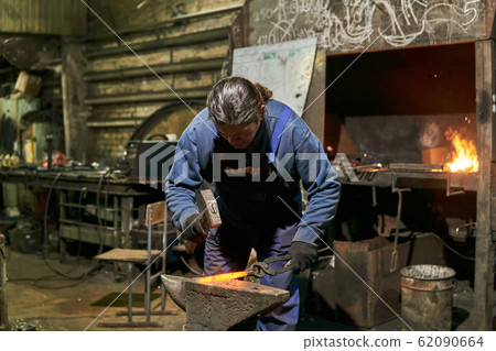 male traditional blacksmith at work 62090664