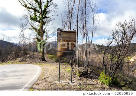 Burnt sign on the road after a forest fire in Monchique, Portugal. Portimao, Monchique, Alcaria do Peso, village name, weight. 62090939
