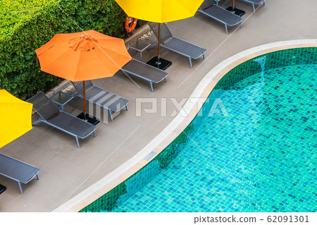 Beautiful outdoor swimming pool in hotel resort for holiday vacation Beautiful outdoor swimming pool in hotel resort for holiday vacation 62091301