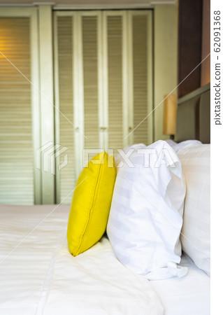 Pillow and blanket on bed with light lamp decoration interior 62091368