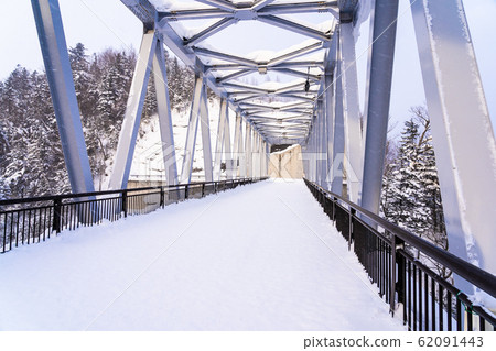 Beautiful outdoor nature landscape with shirahige waterfall and bridge in snow winter season 62091443