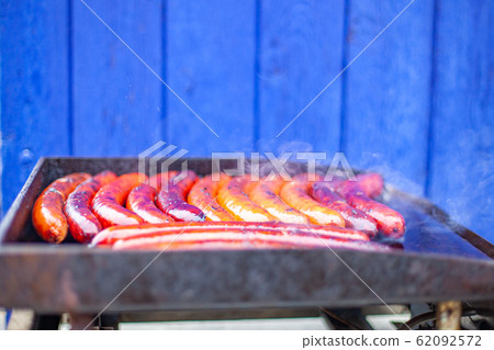 sausage on the grill as a snack during the festival and sports games sausage on the grill as a snack during the festival and sports games 62092572
