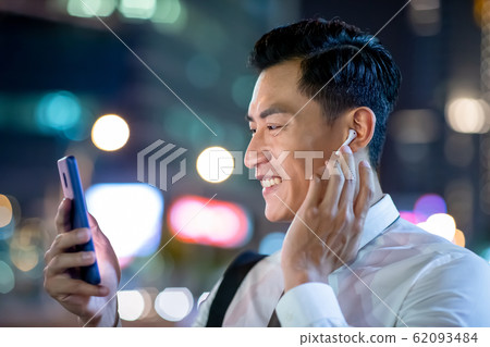asian man wear wireless earbuds asian man wear wireless earbuds 62093484