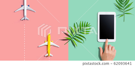 Person using a tablet computer with small airplanes 62093641