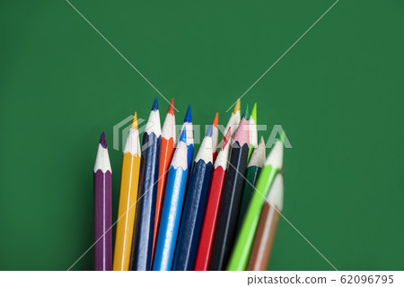 Colored pencil set on green background back to 62096795