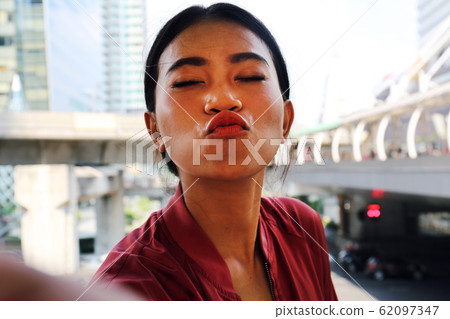 Young woman sport smile portrait and selfie photo relaxation on walking street. Young woman sport smile portrait and selfie photo relaxation on walking street. 62097347