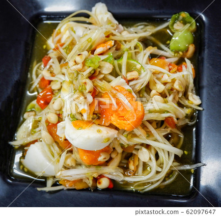 Papaya salad with satled eggs and peanut on plate 62097647