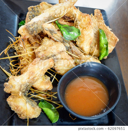 Fried fish crispy with herb lemon grass kaffir Fried fish crispy with herb lemon grass kaffir 62097651