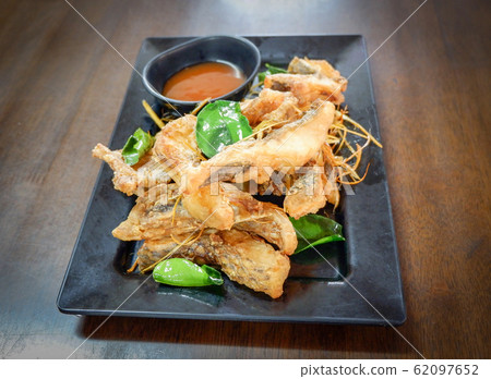 Fried tilapia fish crispy cooked with herb lemon Fried tilapia fish crispy cooked with herb lemon 62097652