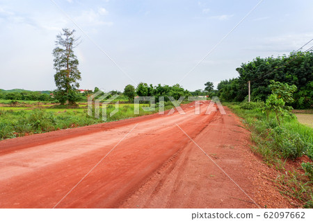 Rural road / dirt road with waterlogging Rural road / dirt road with waterlogging 62097662