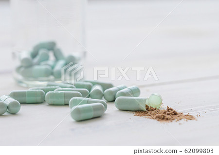 Assorted pharmaceutical medicine capsule pill on wooden table Assorted pharmaceutical medicine capsule pill on wooden table 62099803