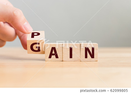 Pain or Gain concept, Hand flip wood cube change the word 62099805