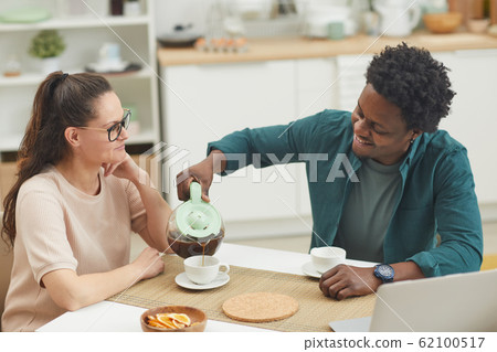 Couple drinking coffee at home Couple drinking coffee at home 62100517