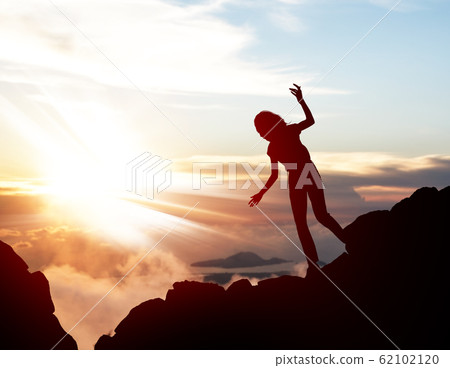 Black silhouette of woman walking down of rock. Black silhouette of woman walking down of rock. 62102120