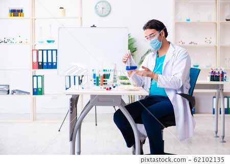 Young male chemist working in the lab Young male chemist working in the lab 62102135