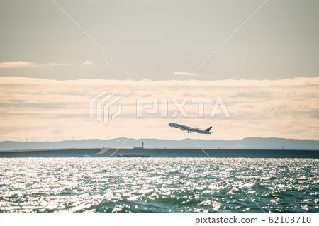 Morning glow and plane 62103710