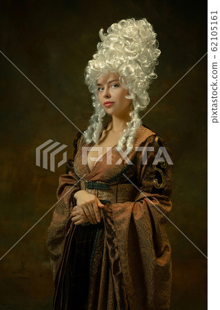 Medieval young woman in old-fashioned costume Medieval young woman in old-fashioned costume 62105161