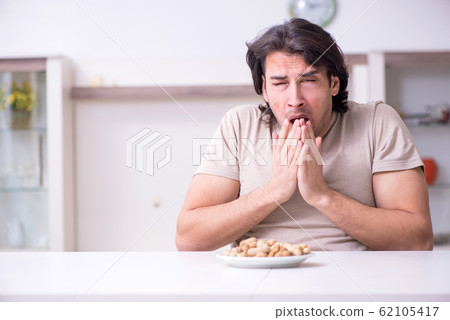 Young man suffering from allergy Young man suffering from allergy 62105417