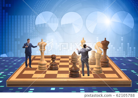 Businessman in large chess board in strategy concept Businessman in large chess board in strategy concept 62105788