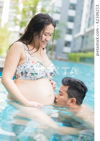 Asian pregnant woman. Mom and newborn baby. Mother Asian pregnant woman. Mom and newborn baby. Mother 62106213