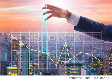 Businessman controlling the market with strings Businessman controlling the market with strings 62106584