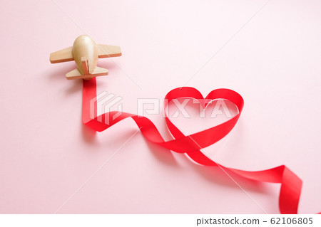 small wooden toy airplane lucky with red ribbon in the shape of heart small wooden toy airplane lucky with red ribbon in the shape of heart 62106805