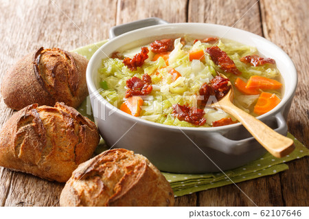 Vegetable cabbage soup with fried bacon served Vegetable cabbage soup with fried bacon served 62107646