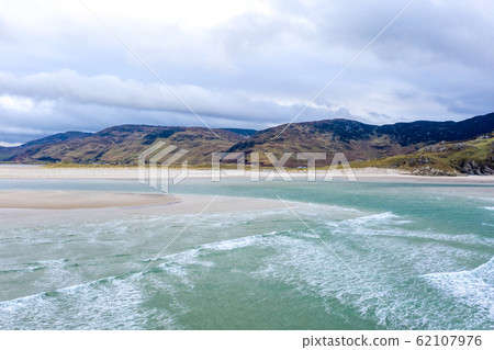 Aerial view of the beach and caves at Maghera Beach near Ardara, County Donegal - Ireland Aerial view of the beach and caves at Maghera Beach near Ardara, County Donegal - Ireland 62107976