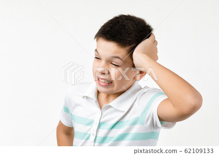 Cute little child boy in striped t-shirt thinks about something Cute little child boy in striped t-shirt thinks about something 62109133
