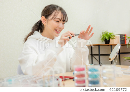 Handmade Women in their 20s making bead accessories Handmade Women in their 20s making bead accessories 62109772