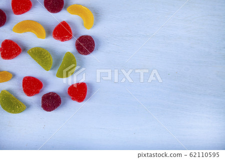 Multicolored marmalade on a blue background. Multicolored marmalade on a blue background. 62110595