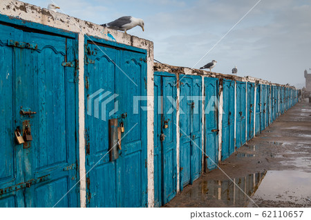 Line of blue doors on an old building 62110657