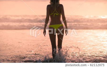 Slender female Silhouette on a background of sea Slender female Silhouette on a background of sea 62112073