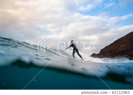 surfer riding waves on the island of fuerteventura surfer riding waves on the island of fuerteventura 62112963
