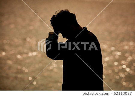 Man holding his head Man holding his head 62113057