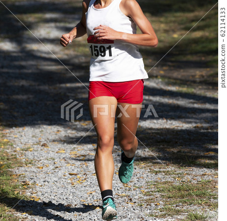 High school girl running 5K race on rocks covered 62114133