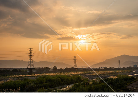 urban sunset scenery with electronic tower 62114204
